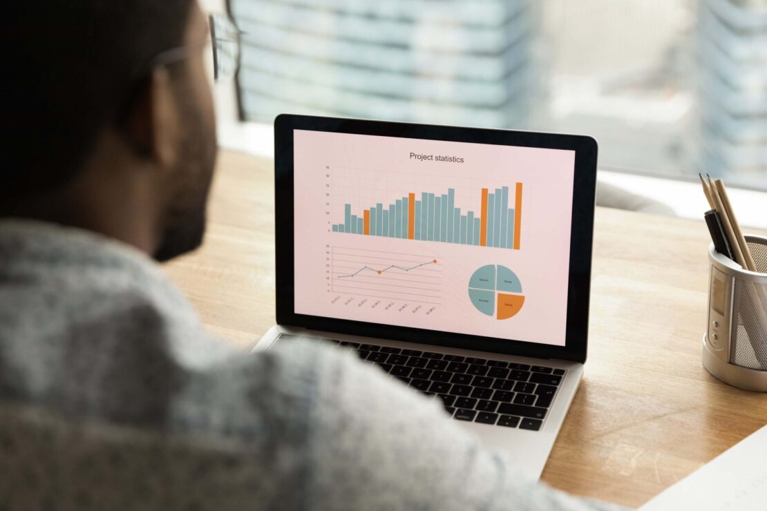 Photo of a Man Looking at Expense Charts